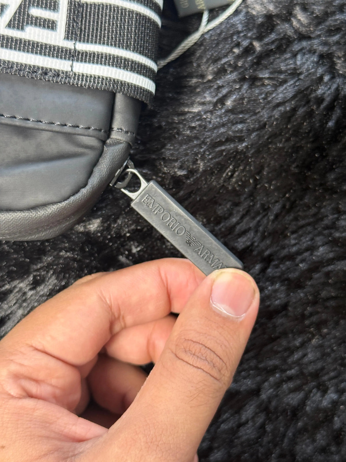 Emporio Armani EA7 black technical fabric crossbody bag featuring a branded logo tape strap and metal eagle logo