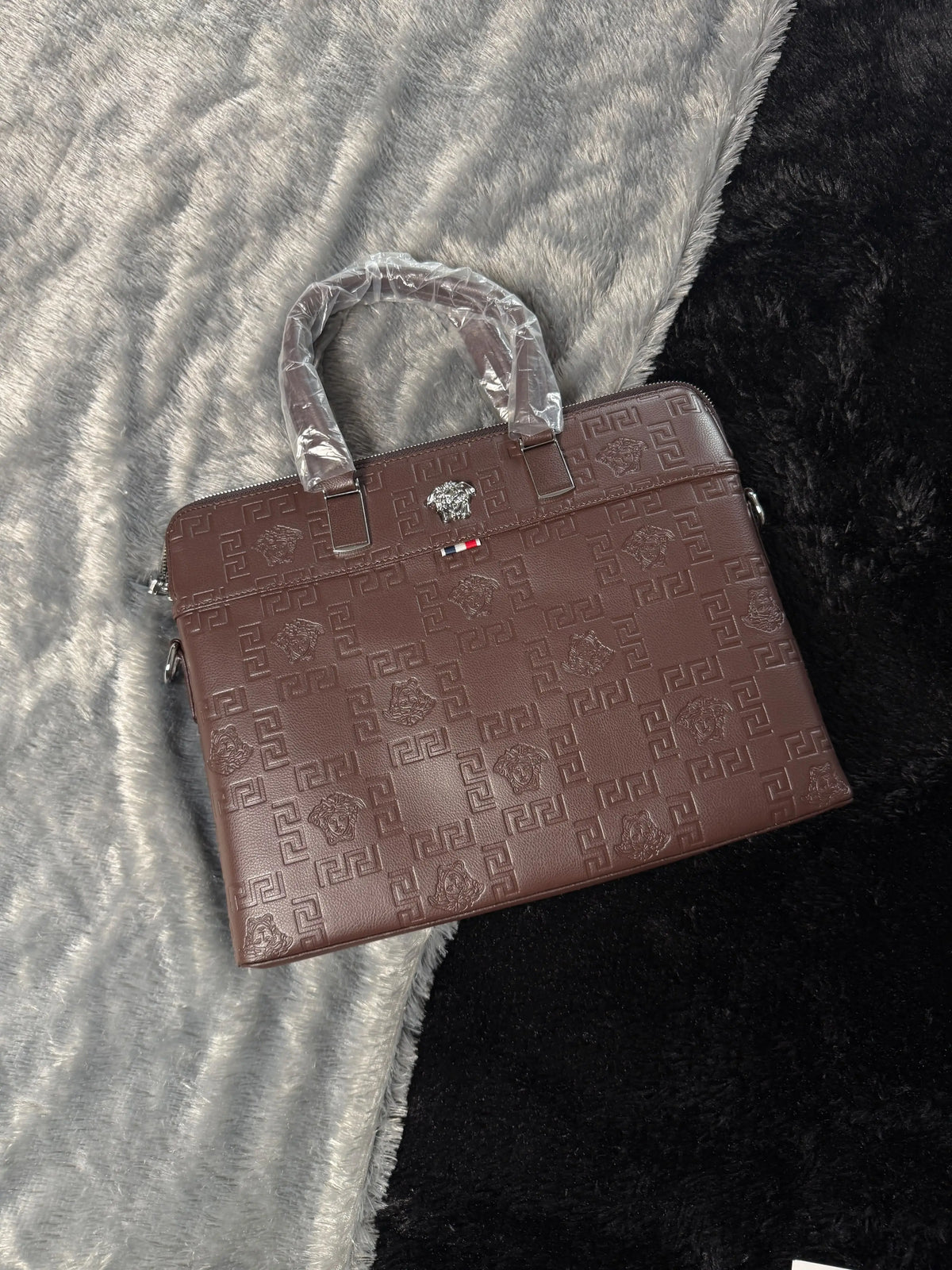 Versace premium laptop bag features an embossed logo Branding