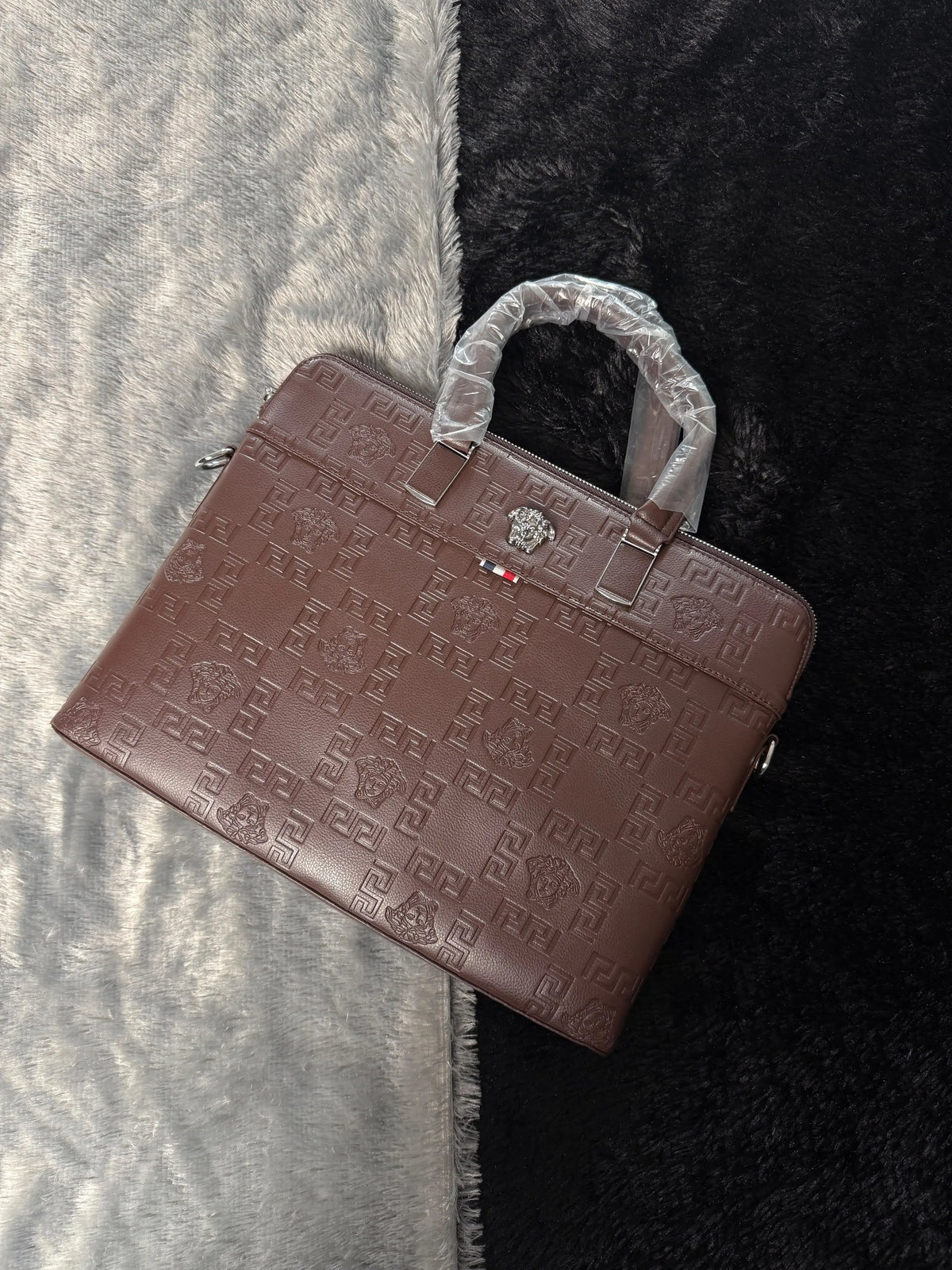 Versace premium laptop bag features an embossed logo Branding