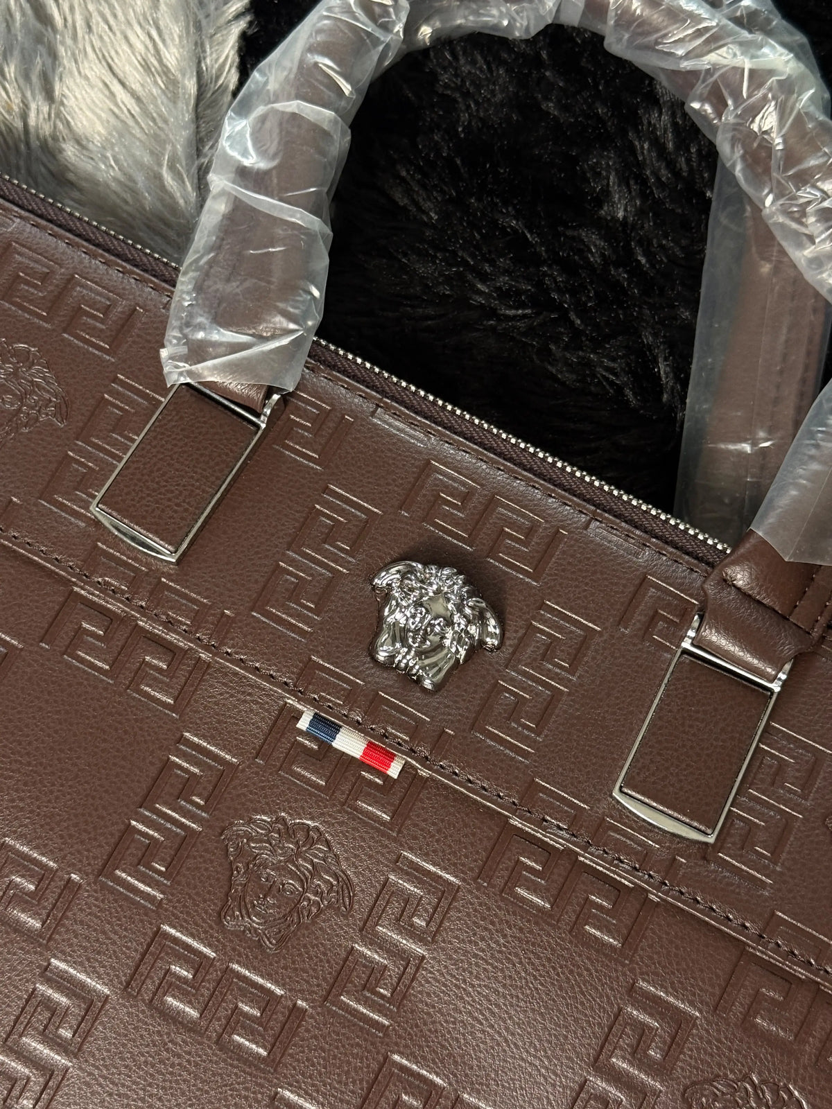 Versace premium laptop bag features an embossed logo Branding