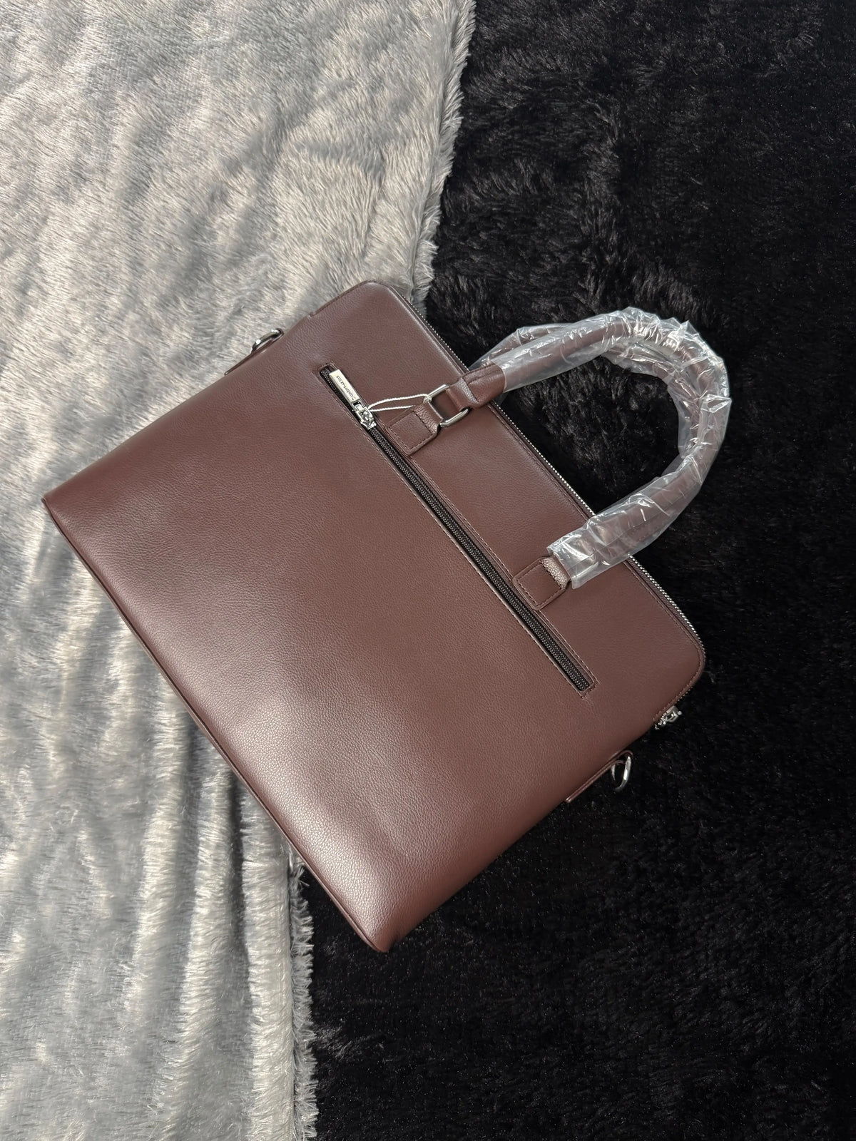 Versace premium laptop bag features an embossed logo Branding