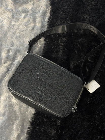 Prada Glace Calfskin Crossbody bag features a signature embossed logo and an adjustable strap