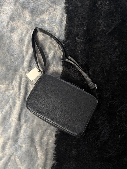Prada Glace Calfskin Crossbody bag features a signature embossed logo and an adjustable strap