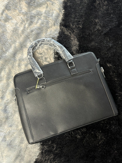 Louis Vuitton Damier Graphite laptop bag features a black checkered pattern and a prominent silver LV logo